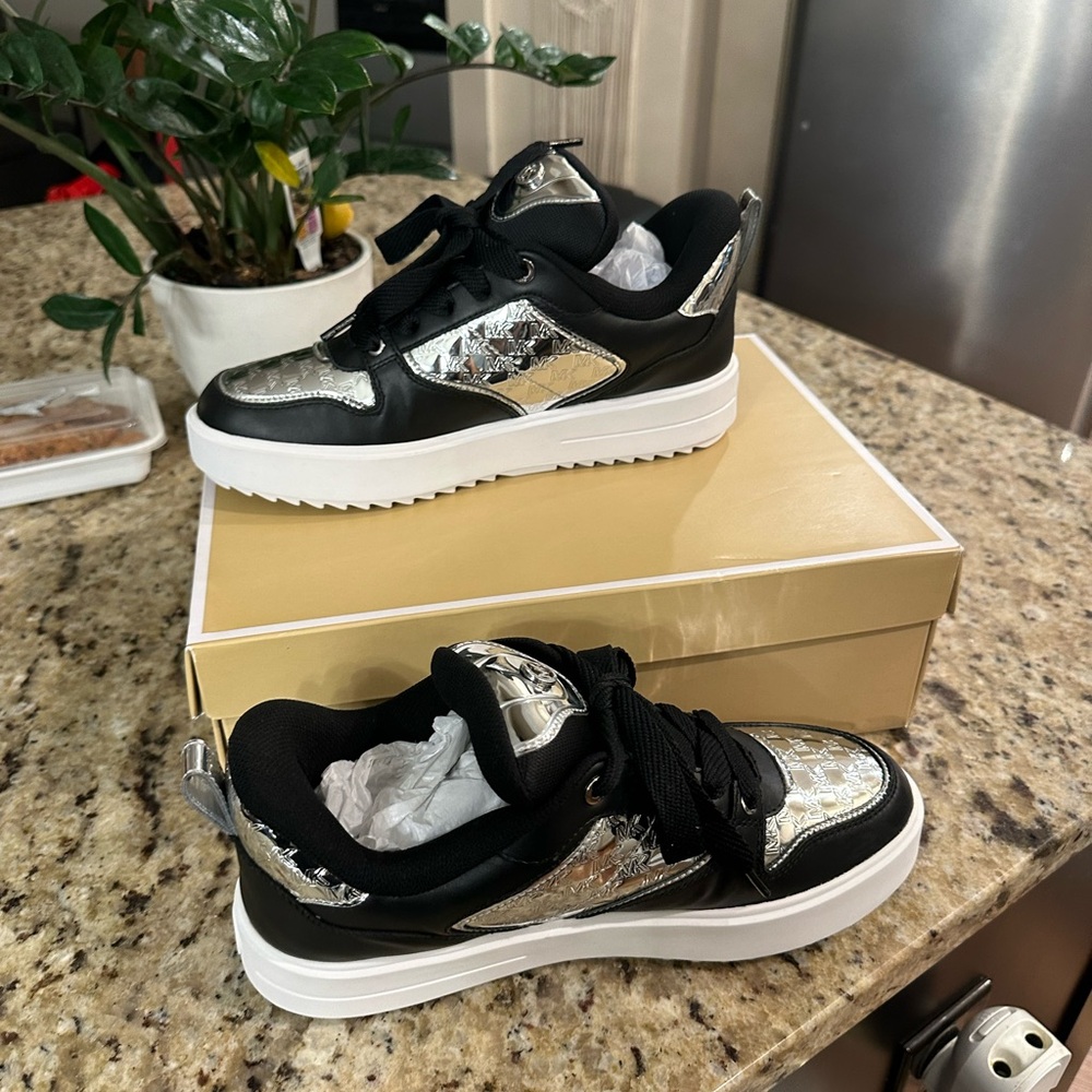 Never worn brand new black and silver sneakers, original box.